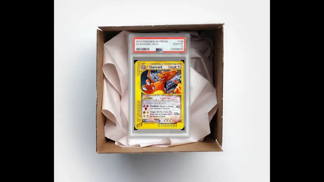 A graded trading card packed securely in a padded shipping box